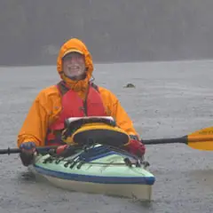 man in a kayak in the rain